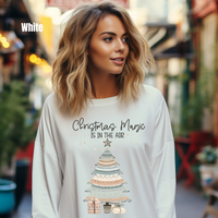 Load image into Gallery viewer, Woman wearing Comfort Colors 6014 white long sleeve with boho Christmas Magic Is In The Air design in festive street setting