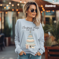 Load image into Gallery viewer, Woman wearing Comfort Colors 6014 chambray long sleeve with boho Christmas Magic Is In The Air design in festive street setting