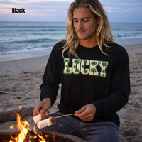 Load image into Gallery viewer, Handsome surfer man with long blonde hair roasting marshmallows on the beach at sunset wearing a black Lucky faux patch long sleeve shirt.
