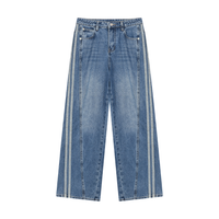 Load image into Gallery viewer, Light blue wide-leg denim jeans with double vertical white stripes running down the outer sides of the legs, shown against a plain white background.