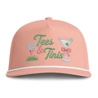 Load image into Gallery viewer, A peach baseball cap with embroidered 'Tees &amp; Tinis' text, a golf ball on a tee, and a martini glass with a red bow on the front.