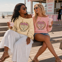 Load image into Gallery viewer, Two women sitting on a bench by the beach, wearing matching sweatshirts with a tennis design.