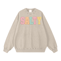 Load image into Gallery viewer, Beige sweatshirt with 'SALTY' in colorful letters on a white background