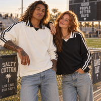 Load image into Gallery viewer, Man and woman wearing ivory and black unisex Varsity Stripe Heavyweight Pullovers beside football field.