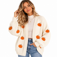 Load image into Gallery viewer, Woman with ivory white knit sweater that has many detailed pumpkins appliquéd on. 