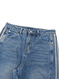 Load image into Gallery viewer, Close-up of a pair of blue denim jeans showing the waistband, belt loops, button, front pockets, and side seam details on a plain white background.