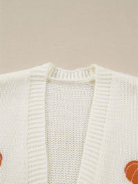 Load image into Gallery viewer, A close up of the Ivory cardigan with orange embroidered pumpkins all over the front.