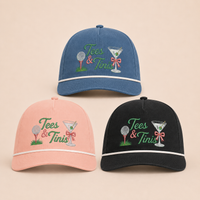 Load image into Gallery viewer, Three baseball caps arranged on a light beige background: a blue cap at the top, a pink cap at the lower left, and a black cap at the lower right. Each cap has embroidered green script reading 'Tees &amp; Tinis' with a martini glass, golf ball, and pink  bow motif.